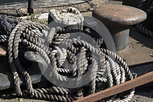 Old frayed rope next to mooring