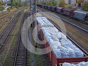 Old freight train with many wagons staying at depot in the city