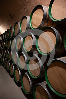 Old french oak wooden barrels in cellars for wine aging process, wine making in La Rioja region, Spain