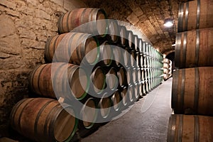 Old french oak wooden barrels in cellars for wine aging process, wine making in La Rioja region, Spain