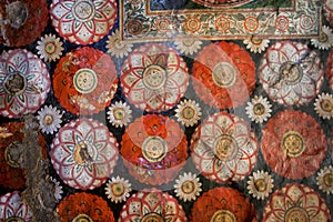 Old fresco with flowers and colorful decor on ceiling of Buddha ancient temple. Sri Lanka religious artwork