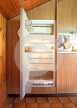 Old fridge in a dated kitchen