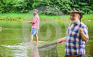 Old friends. family bonding. summer weekend. two fishermen with fishing rods, selective focus. mature man fisher. hobby