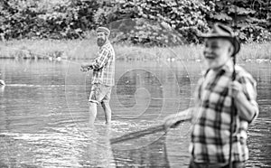 Old friends. family bonding. summer weekend. two fishermen with fishing rods, selective focus. mature man fisher. hobby