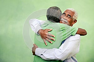 Old friends, two senior african american men meeting and hugging