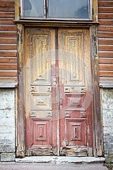 The old front wooden door is rotten at the bottom