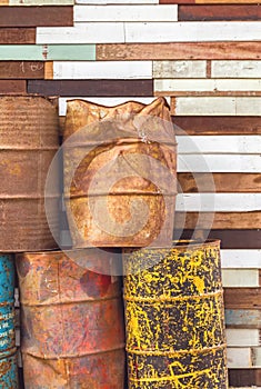 Old fuel tanks that lay altogether and grunge wooden background