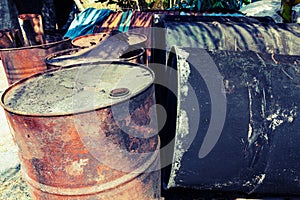 Old fuel tanks that lay altogether processed in vintage style