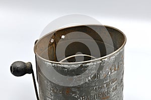 An old but functional flour sifter.