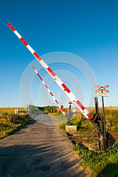 Old funny hand operated railway crossing barrier in the country side of the Czech Republic. Sign Caution train in the