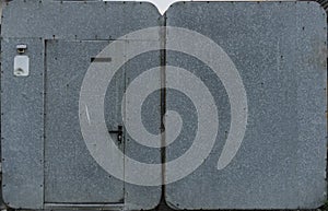 Old galvanized doors. Locks, scuffs and rust stains. Visible nail heads