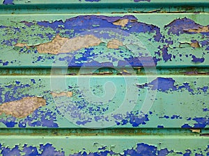 old garage door peeling and flaking blue green white number 2