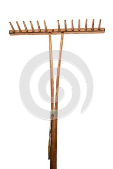 Old garden rake on white background