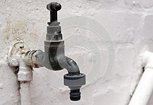 Old garden tap with plastic hose connection