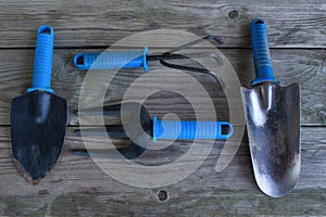 Old garden tools on an old wooden table close-up.