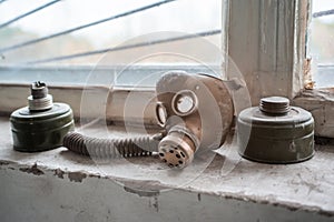 Old gas mask laying on the windowsill in the building located in the Chernobyl ghost town