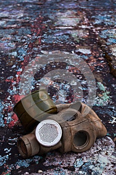 The old gas mask lies on a destroyed concrete floor, a symbol of