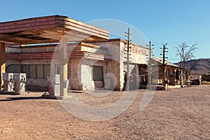 Old gas station in Sahara desert near Ouarzazate, Morocco. Toned image