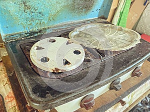 Old gas stove for cooking. burners for gas, pans. two places for cooking. garden appliances for the kitchen. small stove