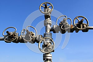 Old gas valves and pipes on blue sky background