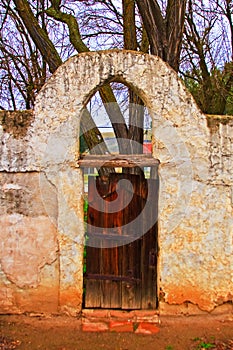 Old gate and arch at Mission San Miguel Arcangel photo