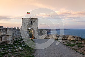 Old gate guarding the entrance of the medieval fortress in Kaliakra Cape, Bulgaria, on a sunny spring day at sunset