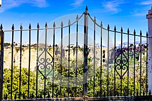 Old gate and Ronda town in distance, Spain