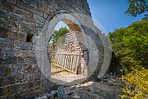 Old gate in a stone fortress wall