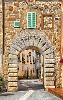 Old gate and the street in medieval tuff city of Sorano, Tuscany