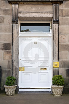 Old Georgian stone townhouse door with fanlight window above door