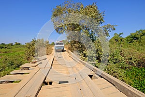 Old german campervan on damaged wooden bridge on the transpantaneira dirt road, Porto Jofre, Mato Grosso, Brazil photo