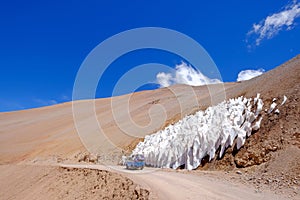 Old german campervan in front of the ice or snow penitentes at at Paso De Agua Negra mountain pass, Chile and Argentina photo