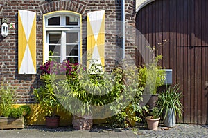 Old German house with windows with wooden shutters, Wachtendonk