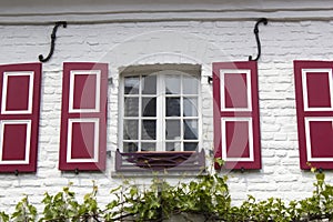 Old German house with windows with wooden shutters, Wachtendonk, Germany