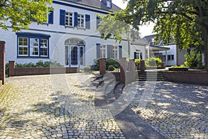 Old German house with windows with wooden shutters in Wachtendonk, Germany