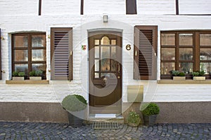 Old German house with wooden door and windows with wooden shutters, Wachtendonk