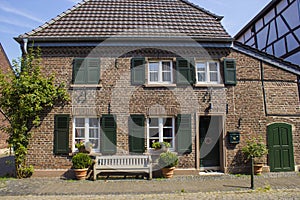 Old German house with wooden door and windows with wooden shutters