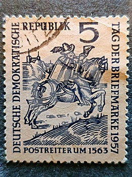 old German stamp circa 1957 with the image of a Postman on horse,