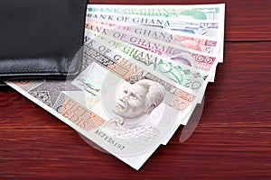 Old Ghanaian Cedis in the black wallet