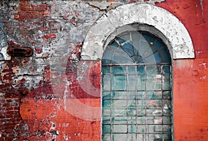 Old glass with an arch and a brick wall