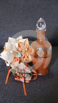 Old glass bottle decorated with origami and biedermeier bouquet