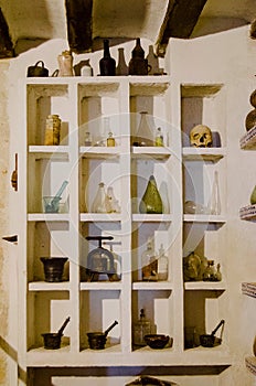 Old glass flasks and bottles in cubicles in the apothecary of the monastery of Santo Domingo de Silos photo