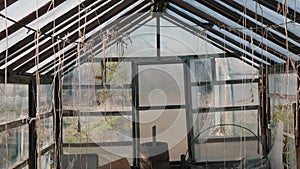 Old glass greenhouse with ropes