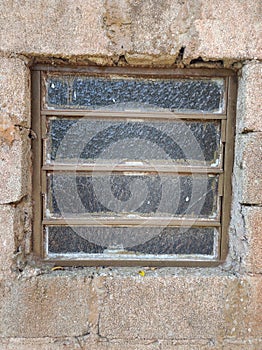 Old glass window on a rustic wall