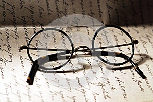 Old glasses on a letter