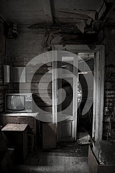 An old gloomy room in an abandoned house. Antique TV.