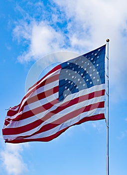 Old Glory Against a Blue Sky and Clouds