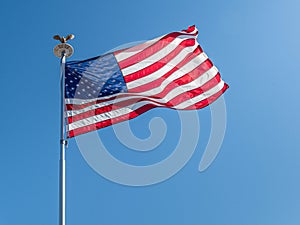 Old Glory Gently Wafting in the Breeze on Clear Blue Sky