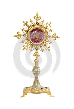 Old gold monstrance with cross inside on white background photo
