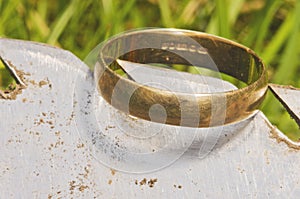 Old gold wedding ring exposed on shovel,found in life dig by metal detector.